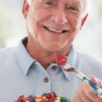 Senior Man Eating Fresh Fruit Salad